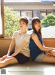 Two young women sitting on a window sill.