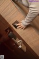 A woman is opening a door with a remote control.