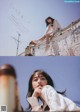 A woman sitting on top of a building next to a wall.